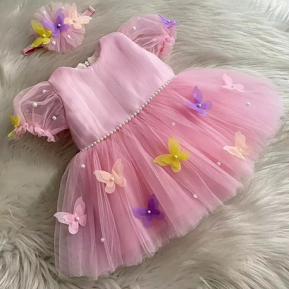Pink butterfly frock with puff sleeves for a baby girl