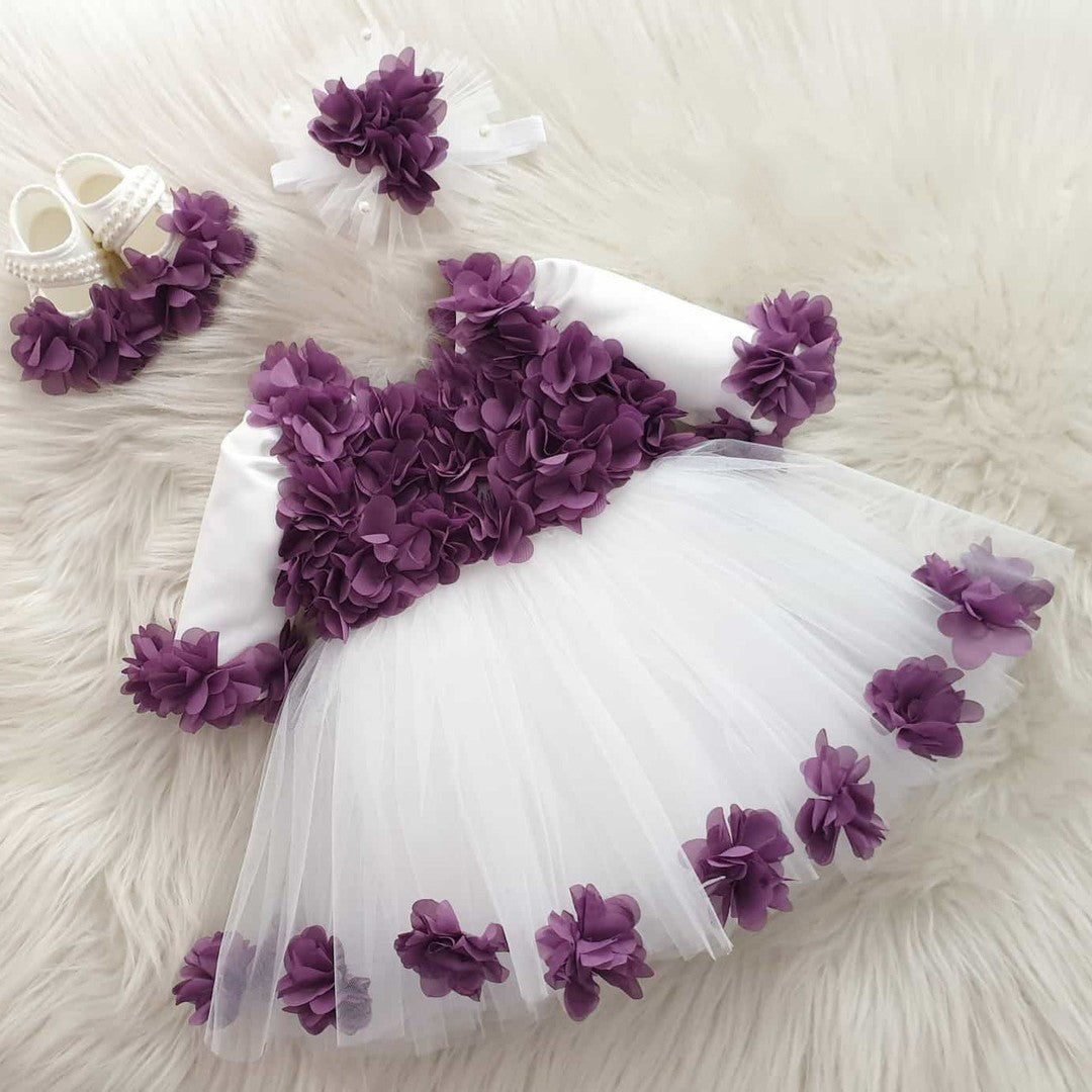 White tulle frock with purple flowers for a baby girl