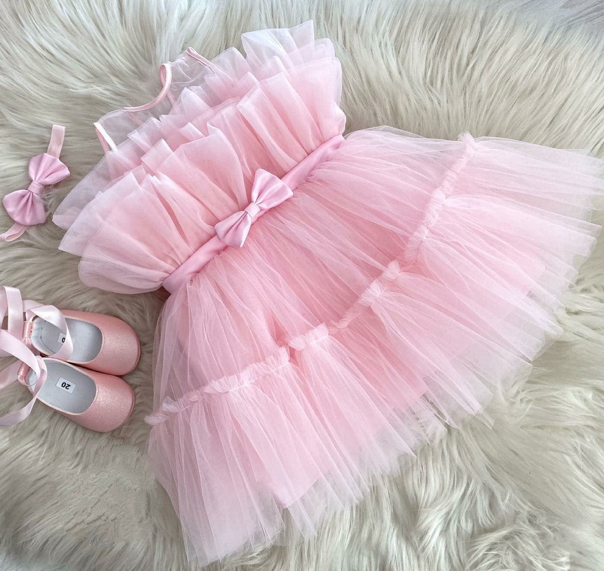 Pink layered tulle frock with satin bow for a baby girl