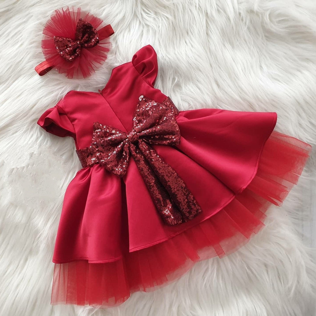 Red tulle frock with sequin bow for a baby girl