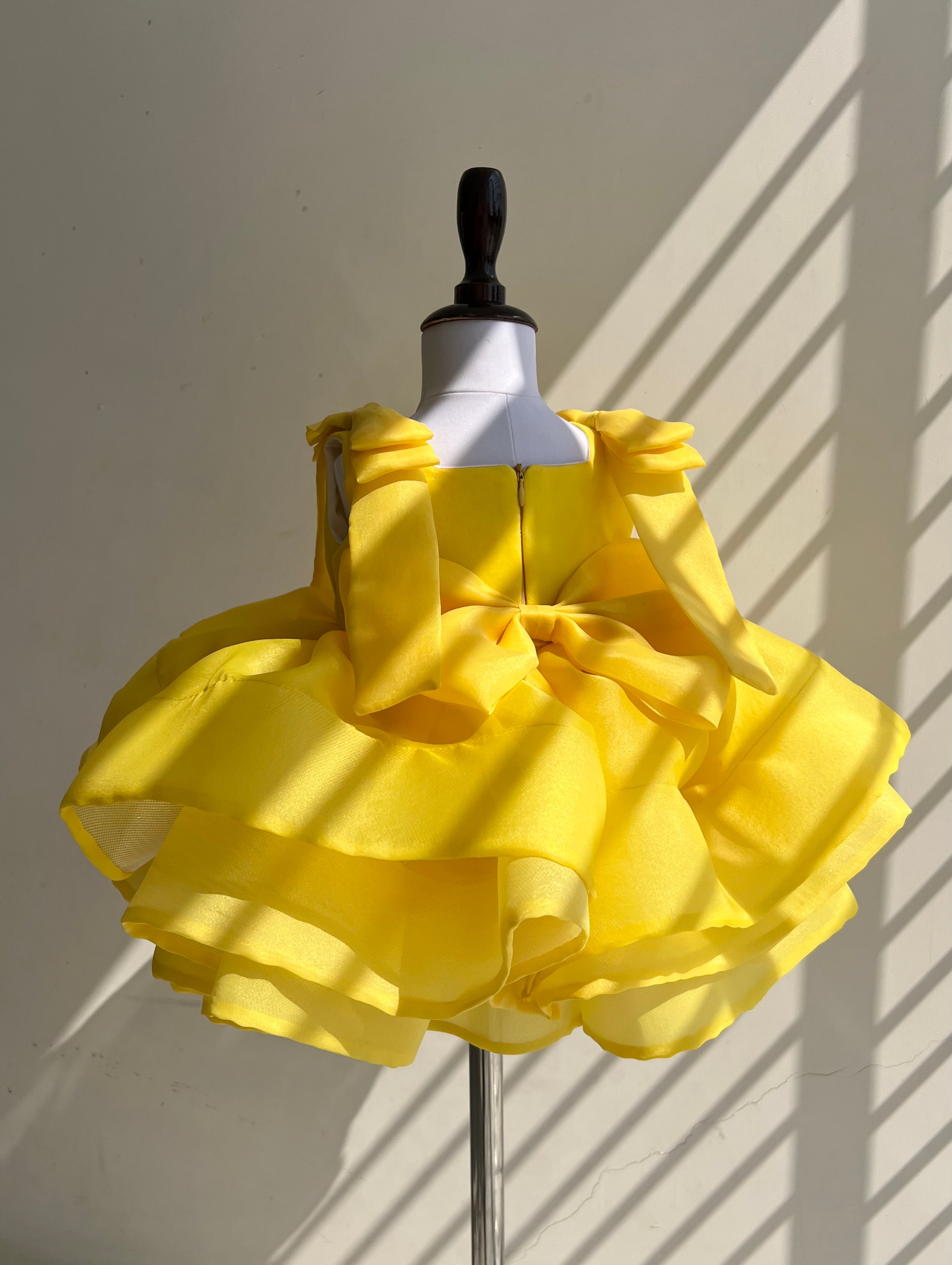 Yellow silk organza frock with bow for a baby girl