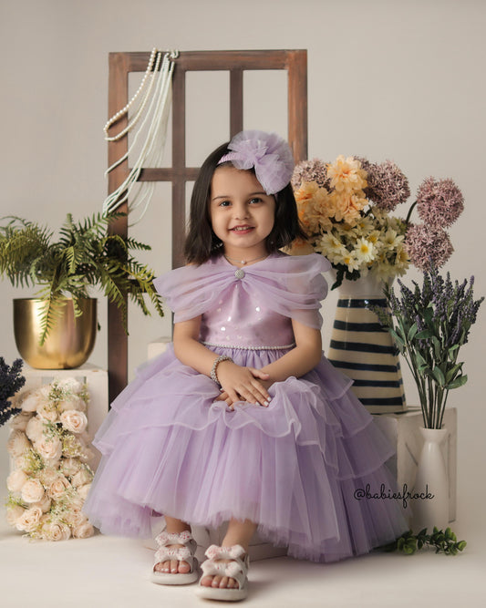 Lilac layered tulle gown for a baby girl