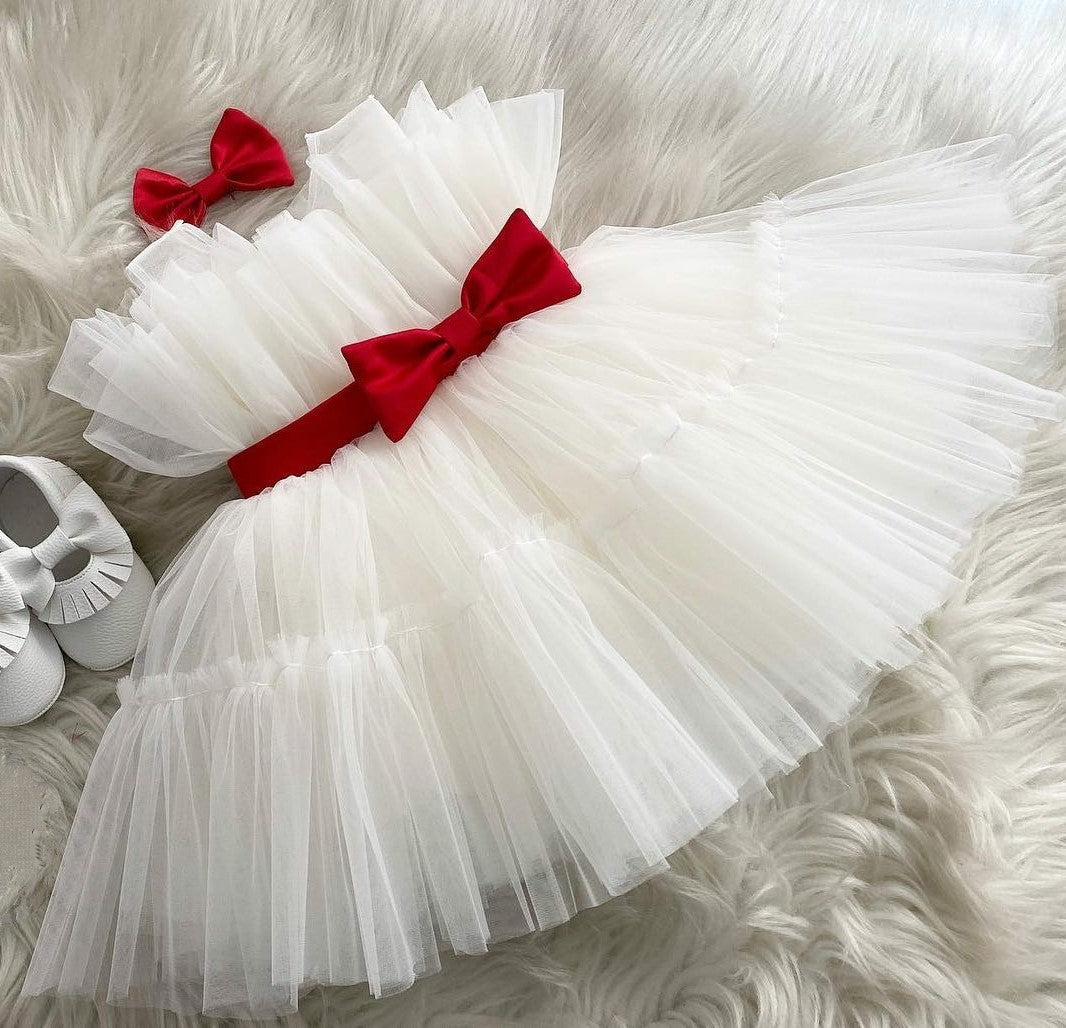 White tulle frock with red bow for a baby girl