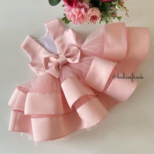 Peach layered satin frock with bow for a baby girl