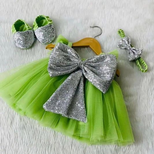 Green tulle frock with silver sequin bow for a baby girl