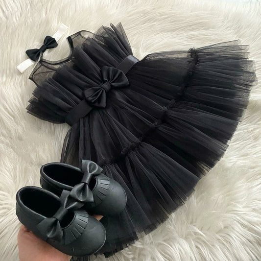 Black tulle frock with bow for a baby girl