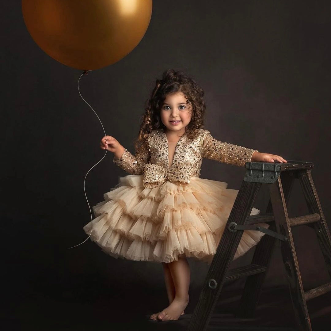 Gold sequin tulle gown for a baby girl