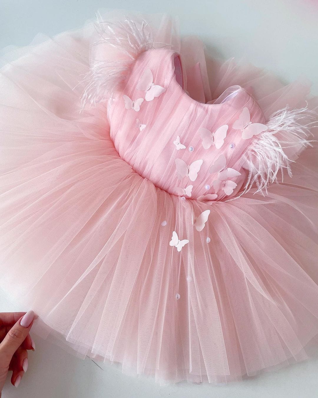 Pink feather sleeve tulle frock for a baby girl