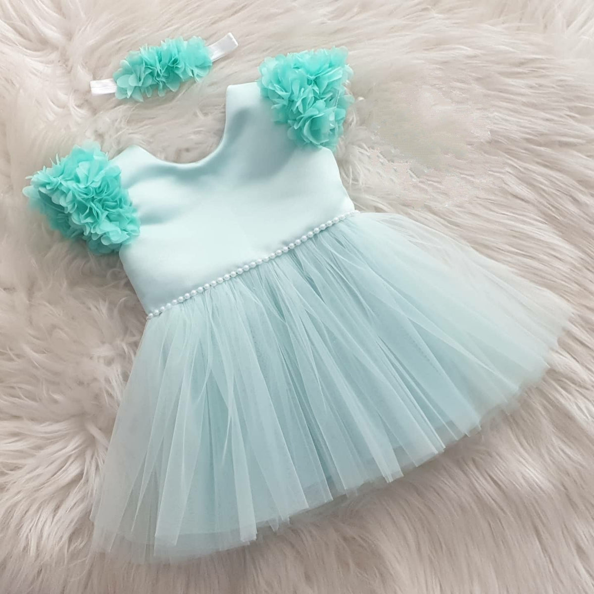 Mint tulle frock with shoulder flowers for a baby girl
