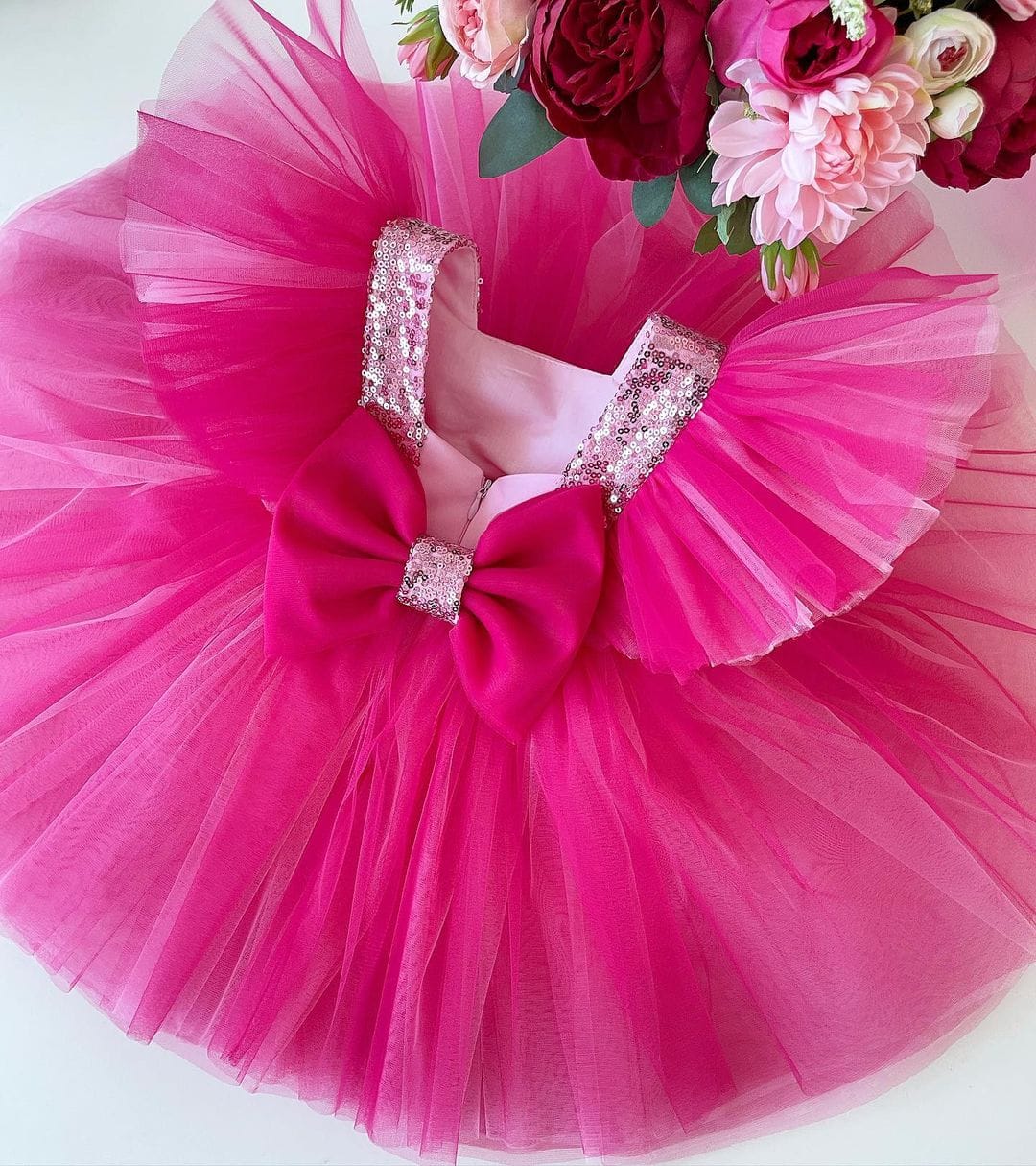 Hot pink tulle frock with sequin trim for a baby girl