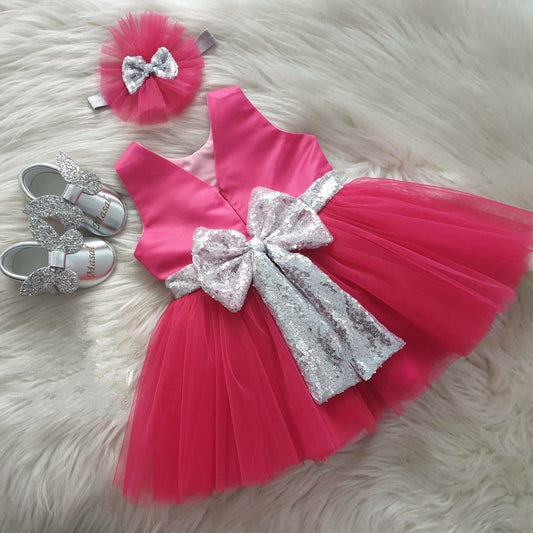 Coral tulle frock with silver sequin bow for a baby girl