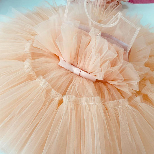 Peach tulle frock with bow for a baby girl